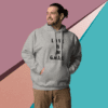 Man in gray hoodie with text stands against a colorful geometric background.