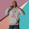 Man wearing a gray hoodie with red text "LIVE is the G.O.A.T.".