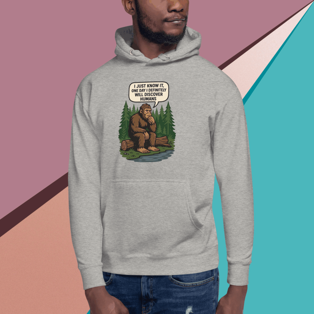 Man wearing a gray hoodie with a vintage-style Bigfoot cartoon graphic.