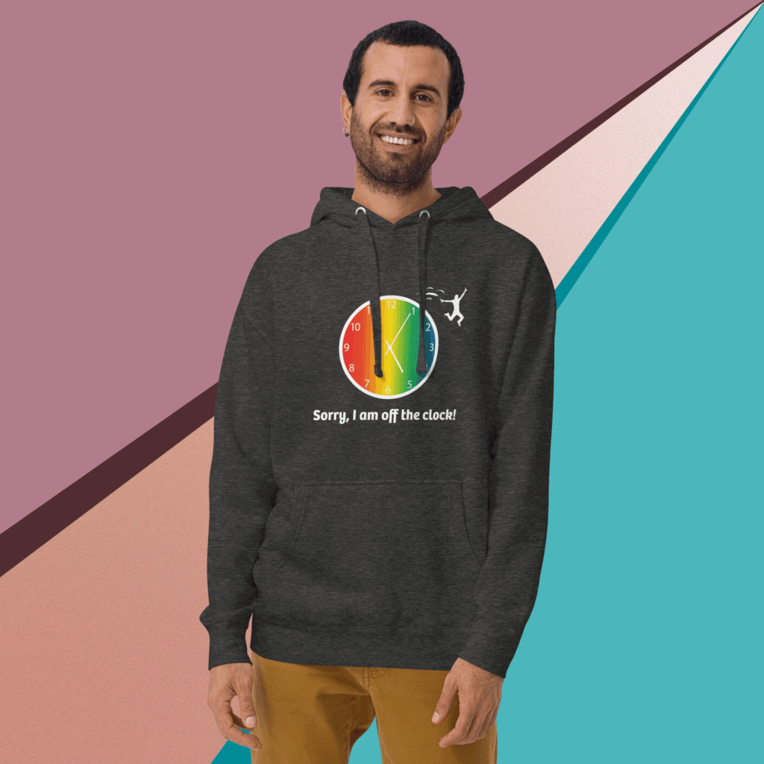 Man smiling in a colorful hoodie against geometric background.