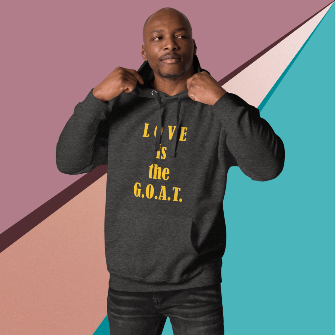 Man wearing a black sweatshirt with "LOVE is the G.O.A.T." text.