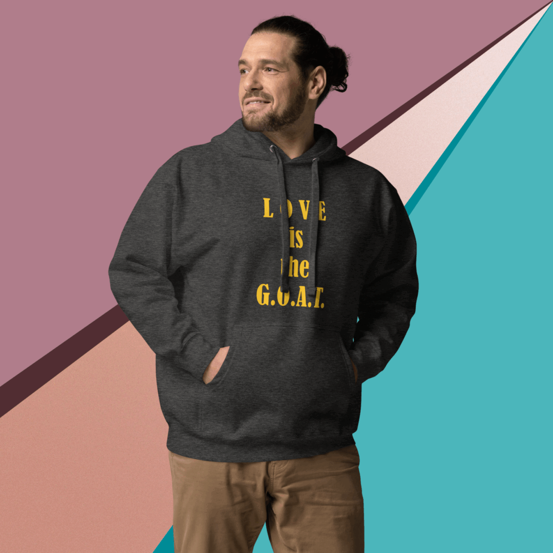 Man wearing a dark hoodie with a motivational quote, smiling.