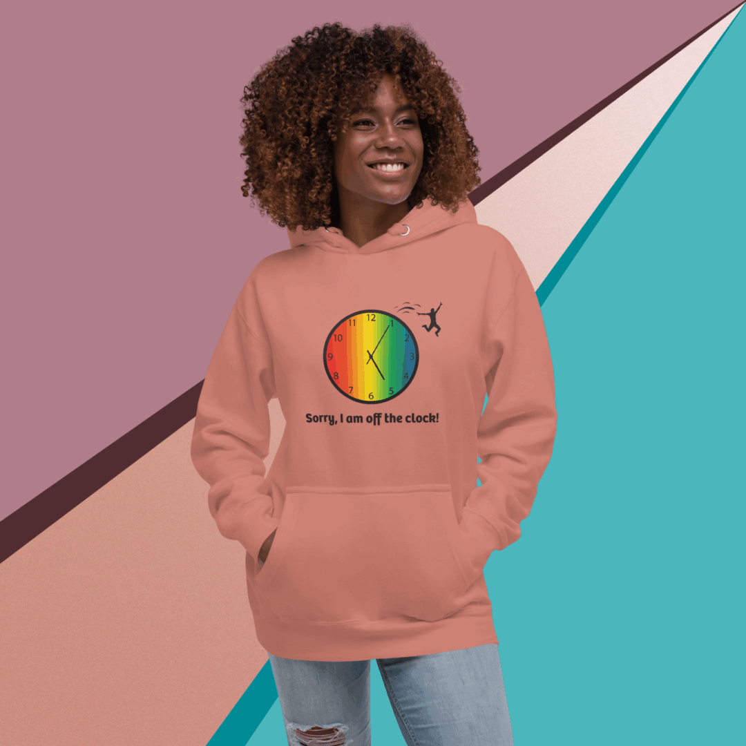 cotton-heritage-m2580-i-unisex-premium-pullover-hoodie-dusty-rose-front-68e323597c446 Smiling woman wearing a peach hoodie with a colorful circular design and text.