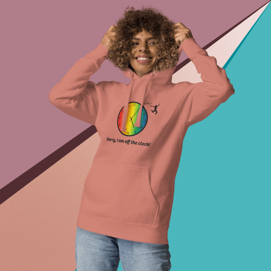 cotton-heritage-m2580-i-unisex-premium-pullover-hoodie-dusty-rose-front-68e3254327fd3 Smiling person in a colorful hoodie against a geometric background.
