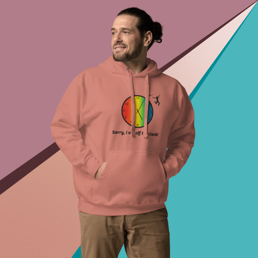 cotton-heritage-m2580-i-unisex-premium-pullover-hoodie-dusty-rose-front-68e3260141bf3 Man in a pink hoodie with colorful design stands against a geometric background.