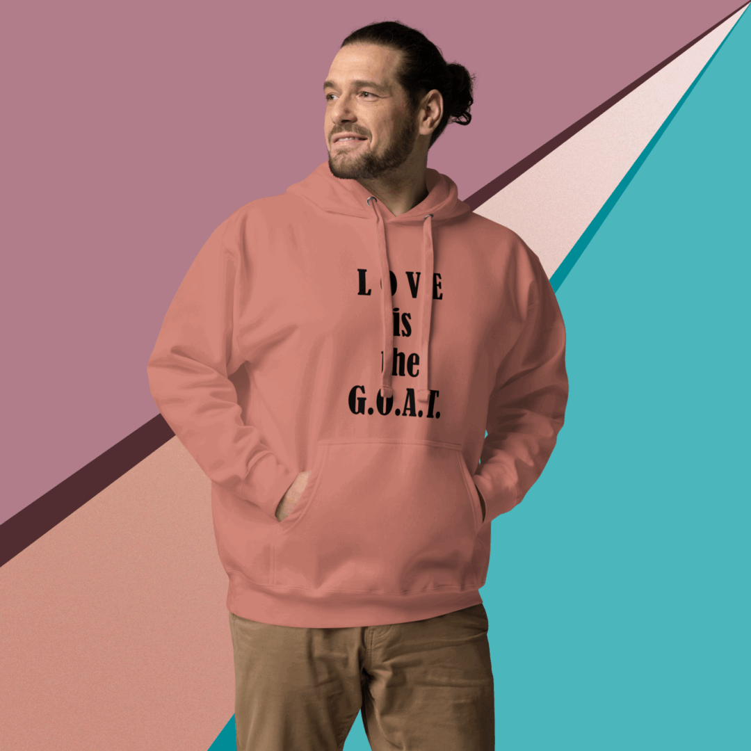 Man wearing a pink hoodie with text, standing against a colorful geometric background.