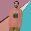 Man wearing a dusty rose hoodie with a graphic design, smiling against a colorful geometric background.