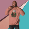 Man in a pink hoodie posing against a geometric colored background.