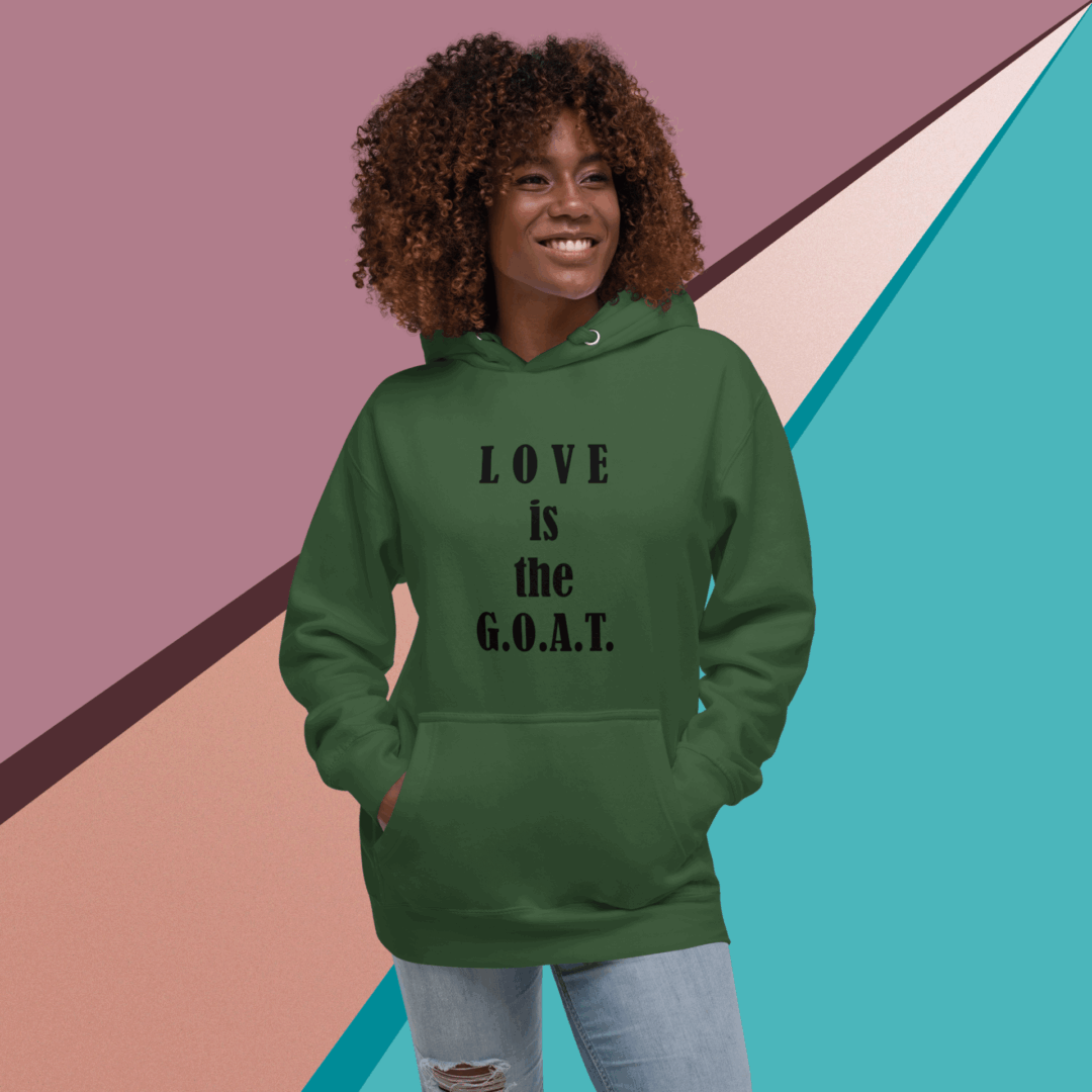 Woman wearing a green hoodie with 'LOVE is the G.O.A.T' text.