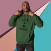 Man in green hoodie pointing to text on it.