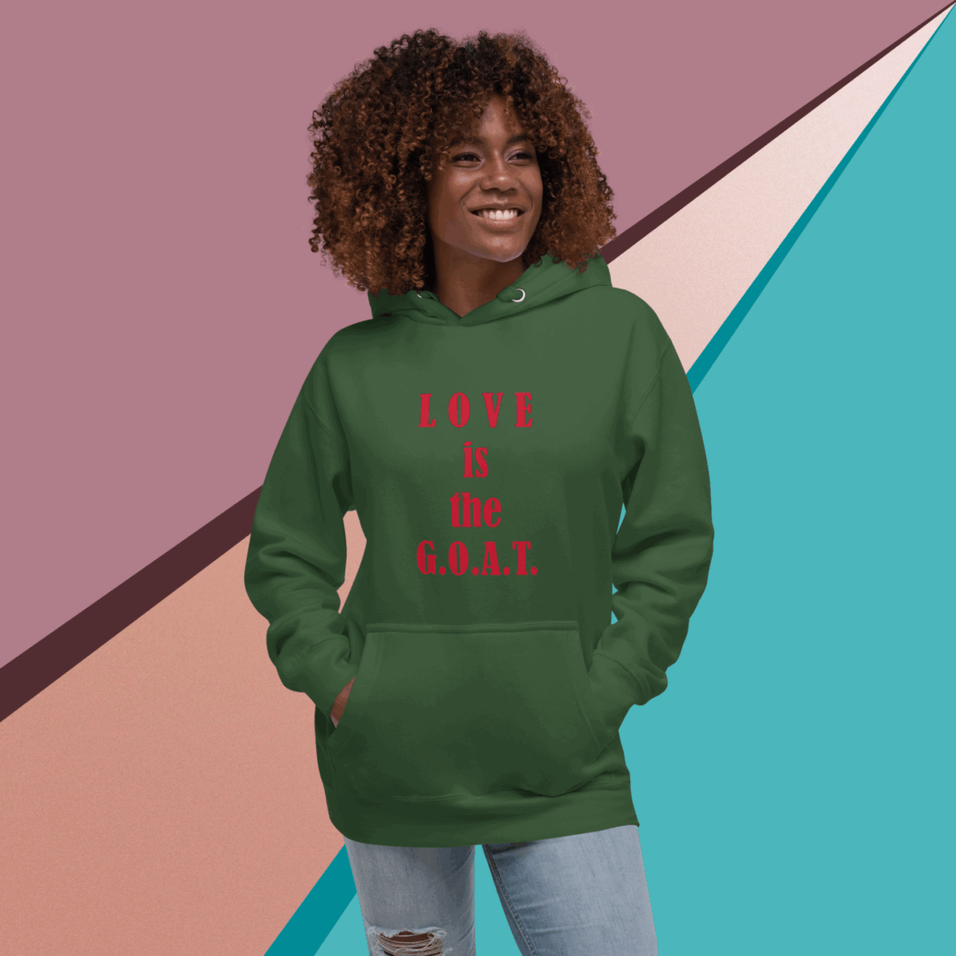 Woman wearing green hoodie with red text, smiling confidently.