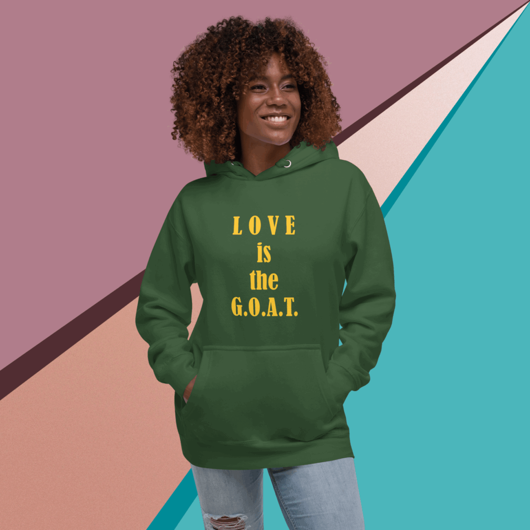 Smiling woman in green hoodie with 'LOVE is the G.O.A.T.' text.