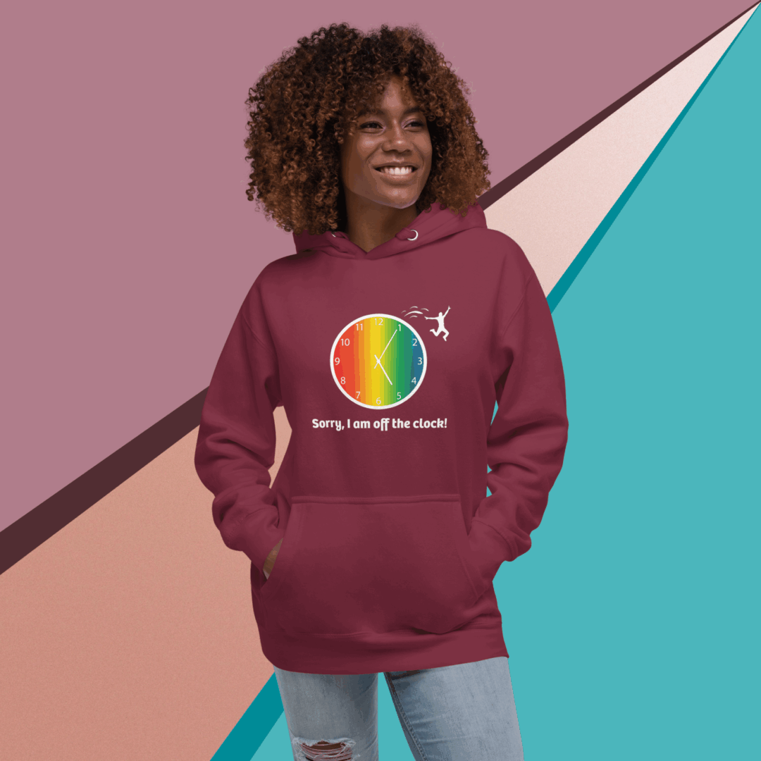 Smiling woman in a colorful, rainbow-themed hoodie.