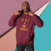 Man wearing a maroon hoodie with gold text.