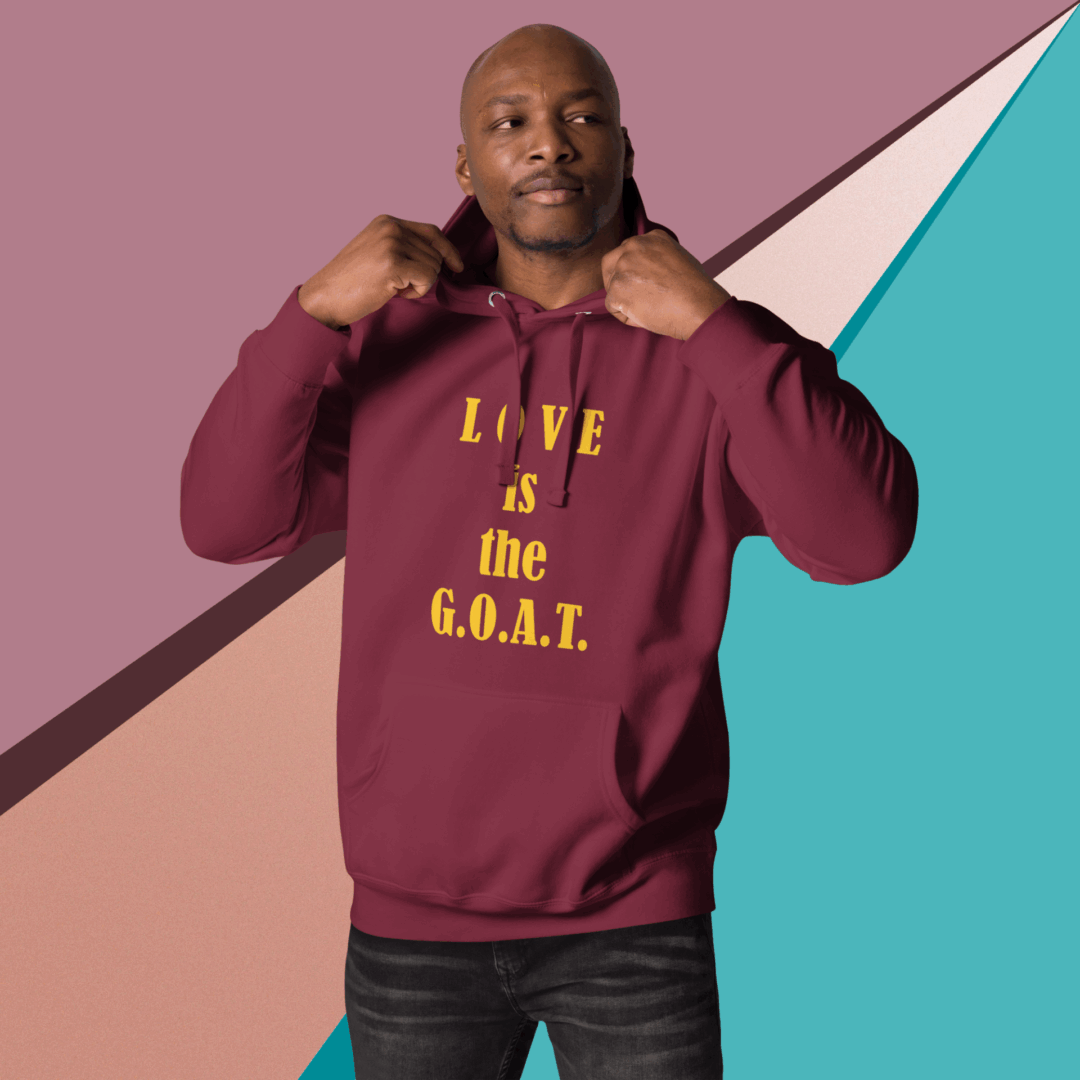 Man wearing a maroon hoodie with gold text.