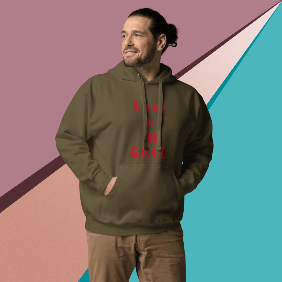 Man wearing an olive green hoodie with red text, standing against a colorful geometric background.