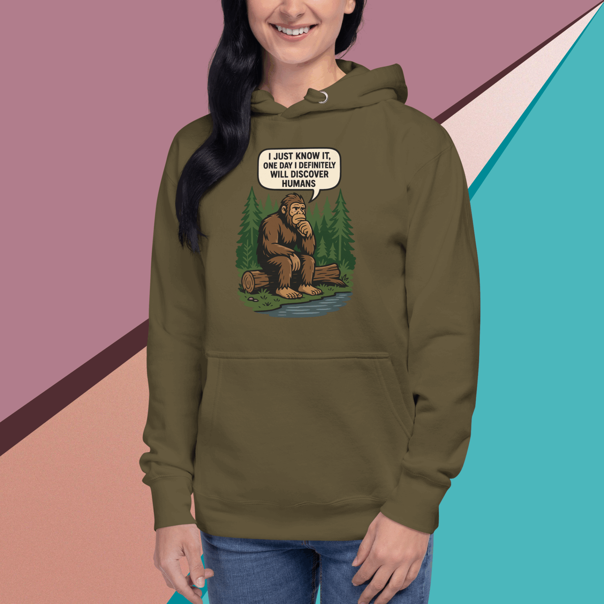 Woman wearing an olive green hoodie with a Bigfoot graphic and humorous text.