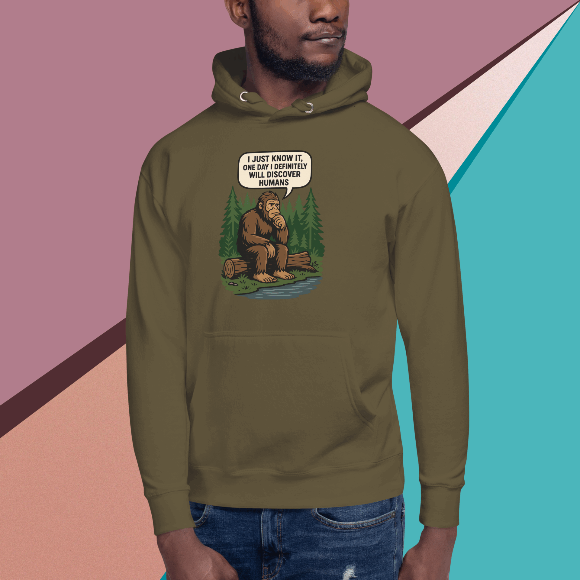 Man wearing an olive green hoodie with a humorous Bigfoot illustration.