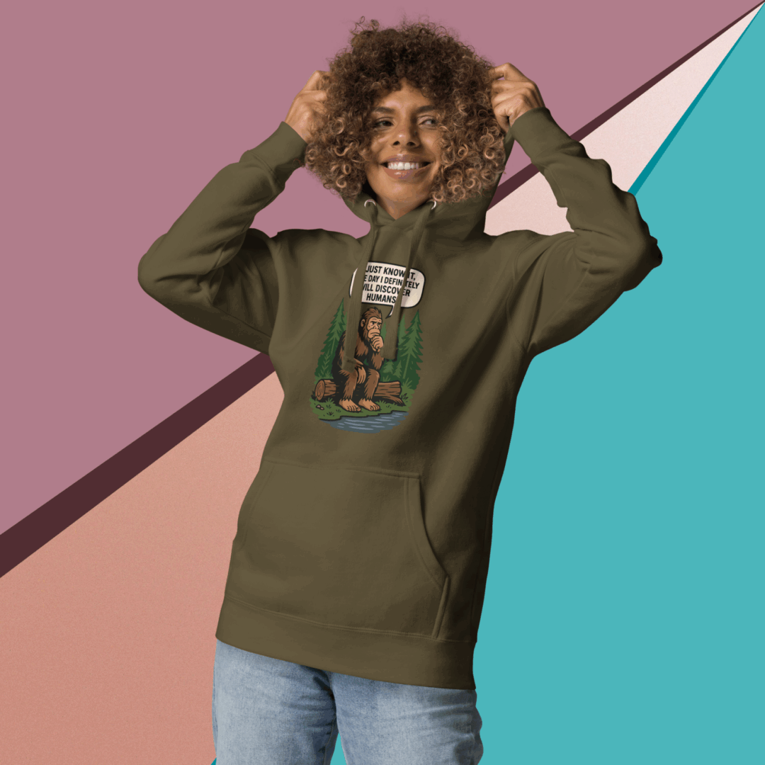 Smiling young man in a green hoodie with graphic design, posing against a colorful geometric background.
