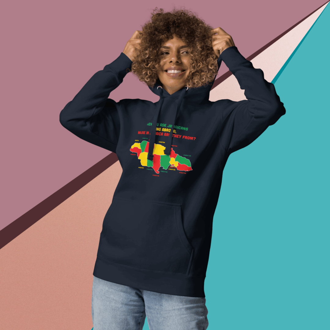 Smiling person wearing a dark hoodie with colorful text, posing against a geometric background.