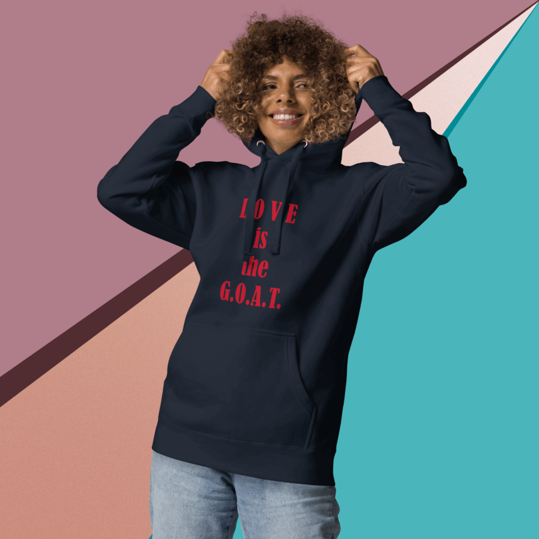 Woman smiling in a black hoodie with red text, standing against a colorful geometric background.
