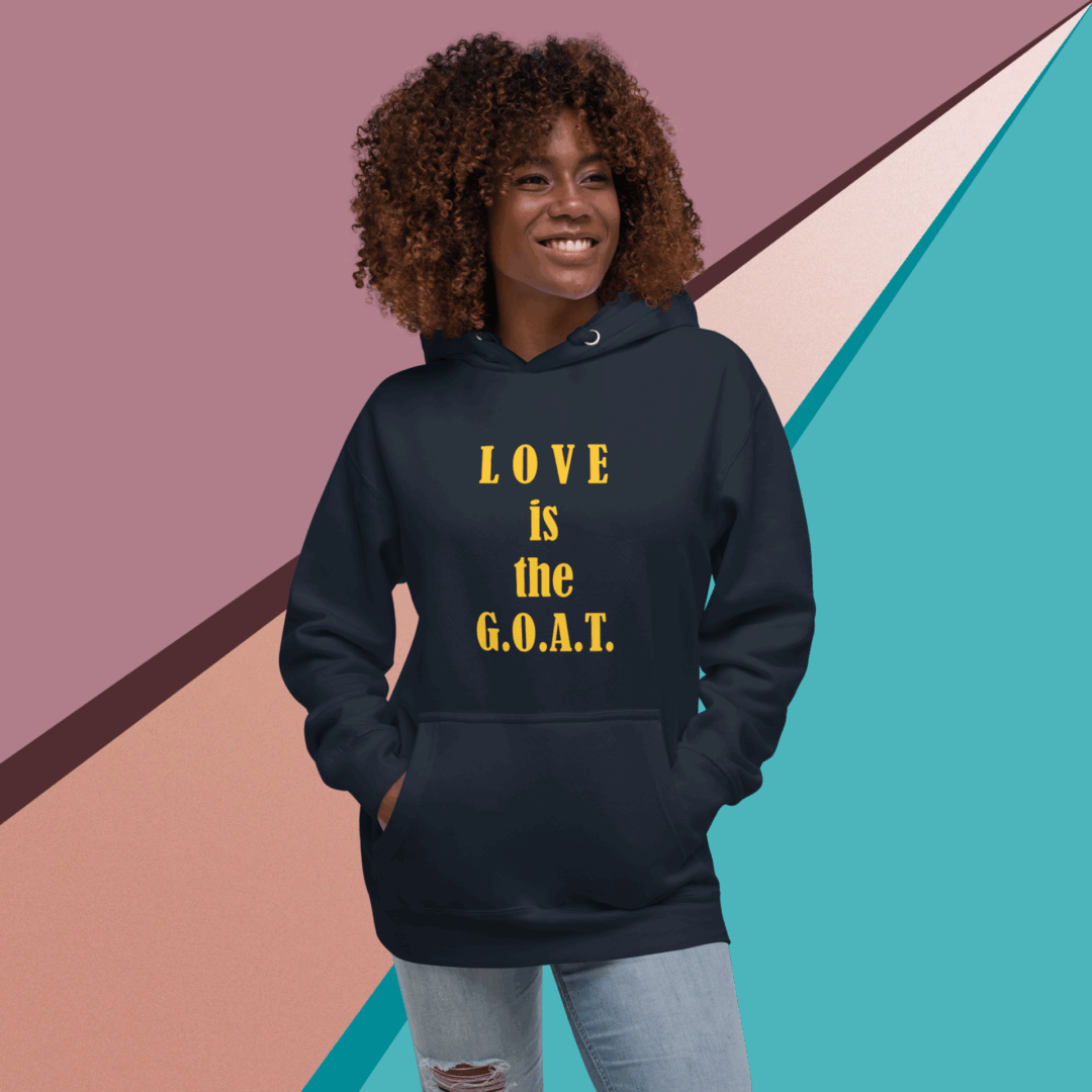 Woman wearing a navy hoodie with 'LOVE is the G.O.A.T.' text.