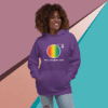 Smiling woman wearing a purple hoodie with a colorful rainbow logo.