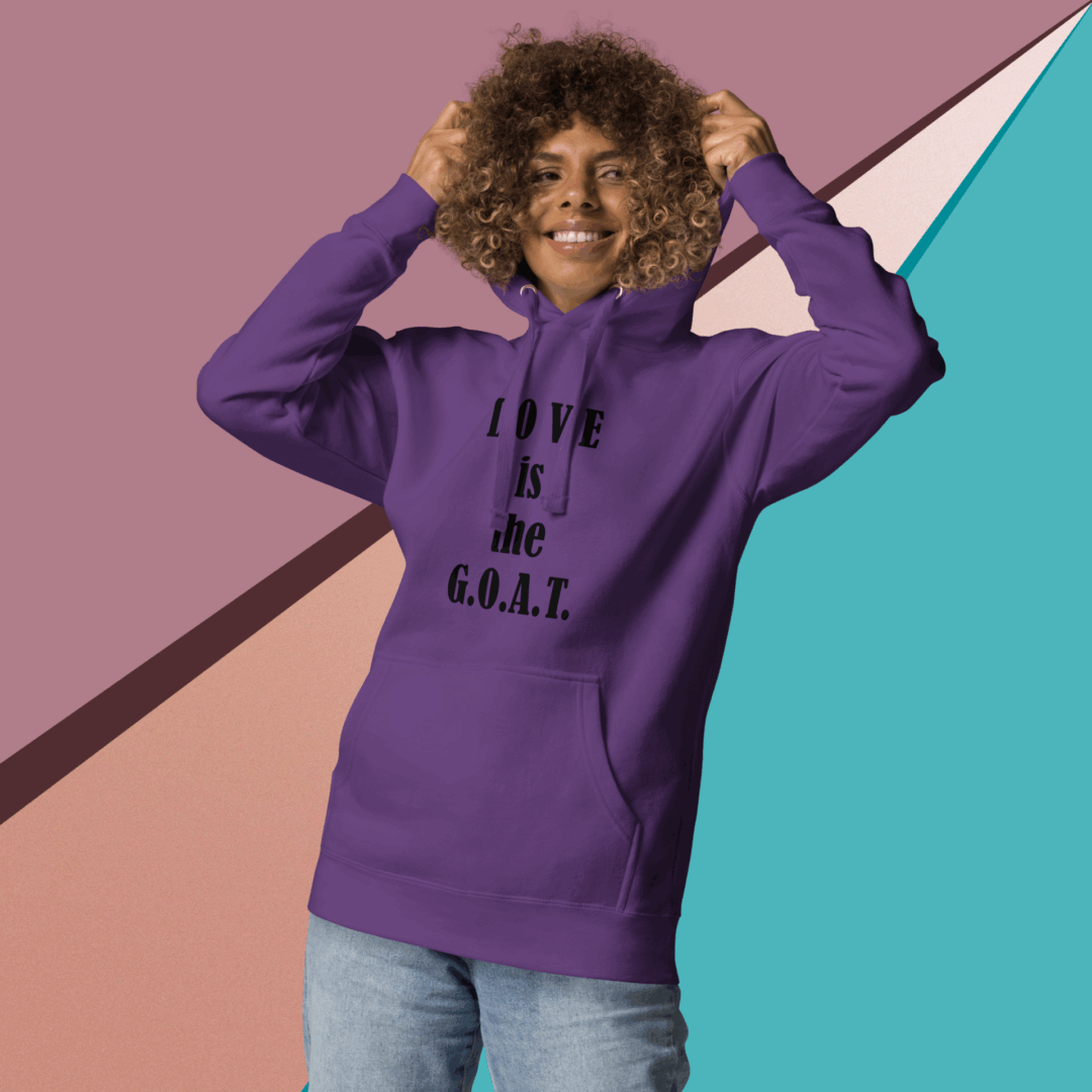 Smiling woman in a purple hoodie with text, posing against a colorful geometric background.