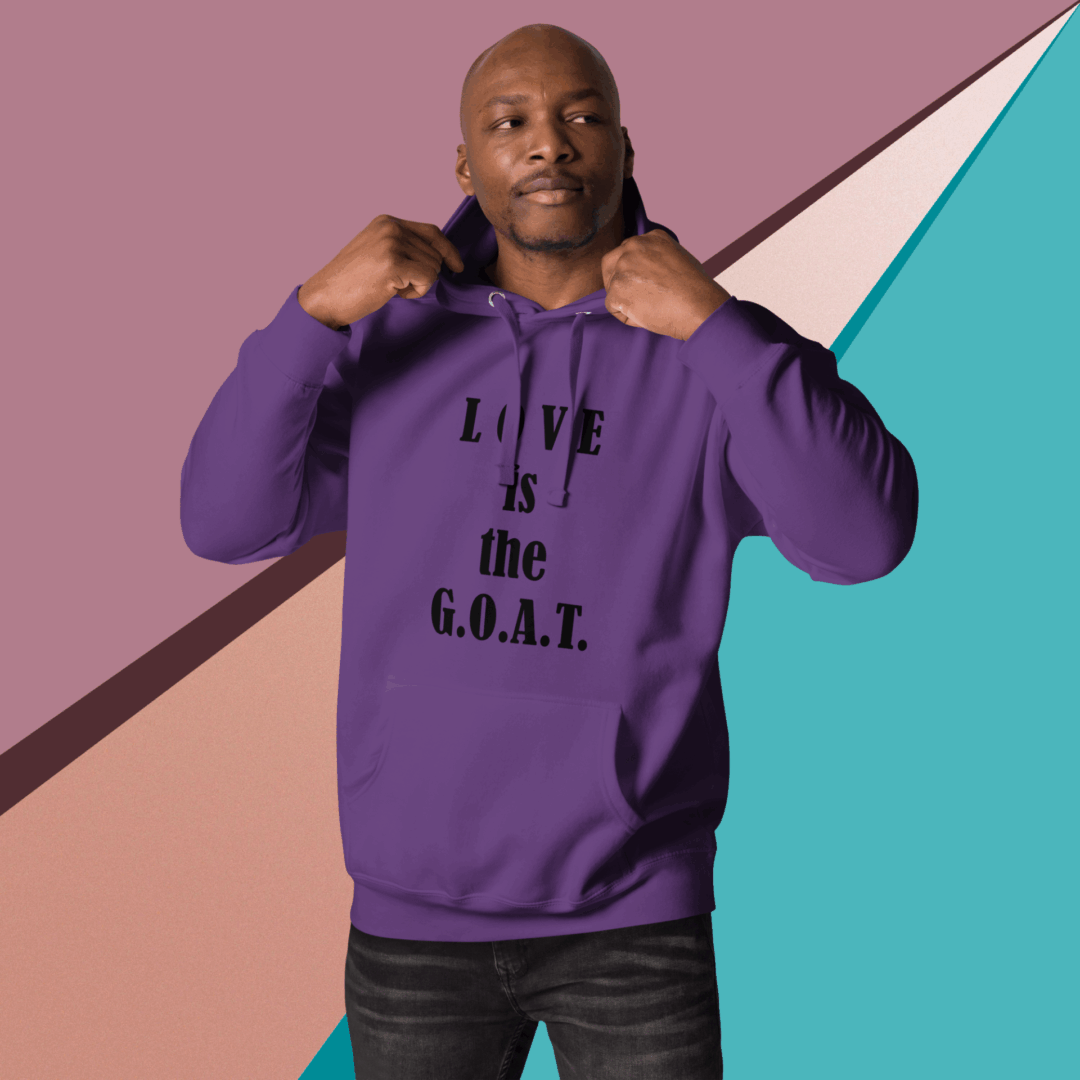 Man in purple hoodie pointing to hoodie text.
