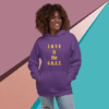 Woman wearing a purple hoodie with 'LOVE is the G.O.A.T.' text.