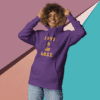 Person wearing a purple hoodie with 'LOVE IS GLOBAL' text.