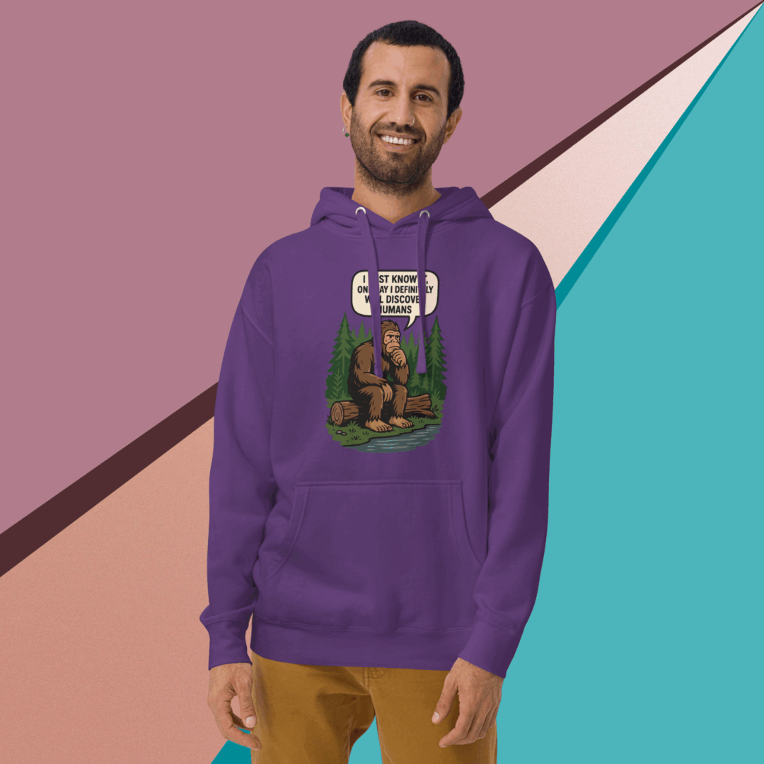 Man wearing a purple hoodie with a graphic print, smiling.