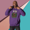 Man posing confidently in a purple hoodie against a geometric background.
