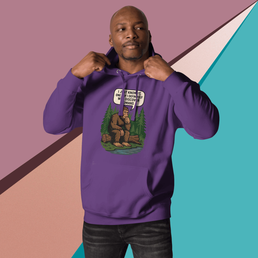 Man posing confidently in a purple hoodie against a geometric background.