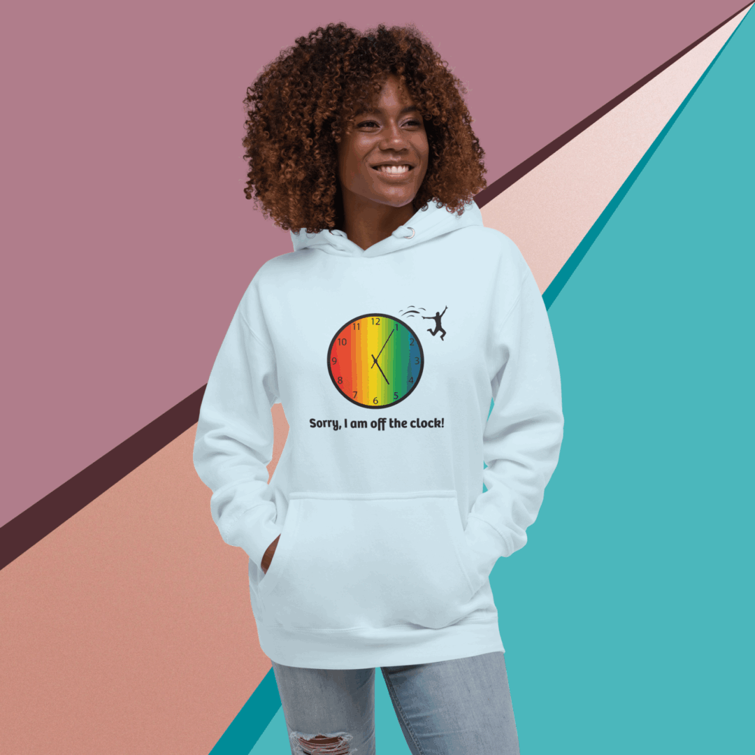 cotton-heritage-m2580-i-unisex-premium-pullover-hoodie-sky-blue-front-68e323597fc00 Smiling woman in a colorful graphic hoodie against geometric background.