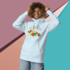 Smiling person wearing a colorful graphic hoodie against a geometric background.