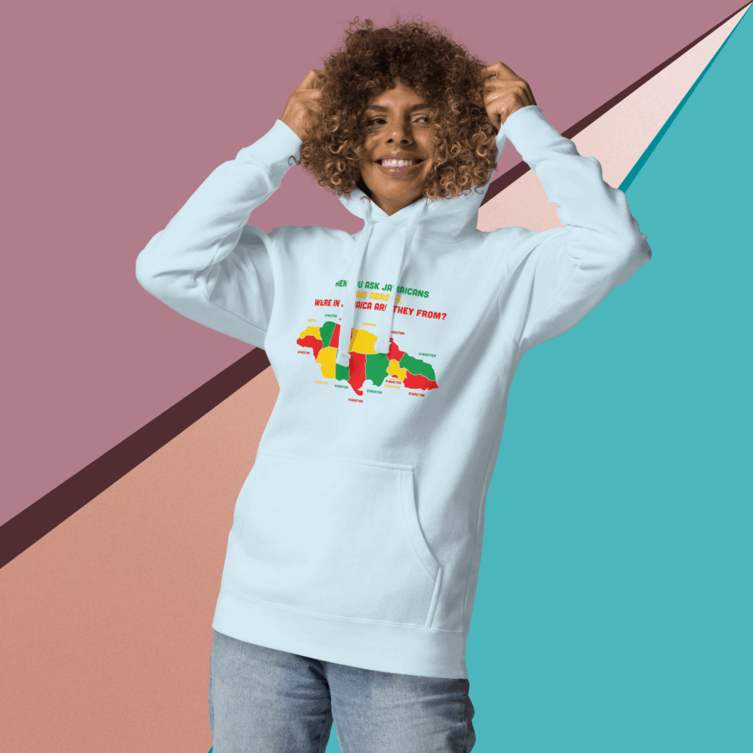 Smiling person wearing a colorful graphic hoodie against a geometric background.