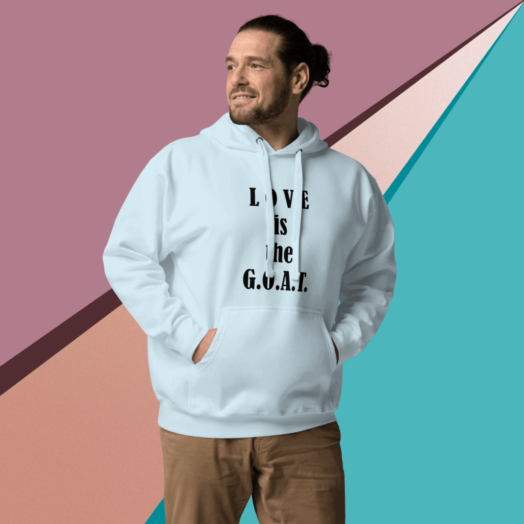 Man wearing a white hoodie with text, standing against a geometric pastel background.