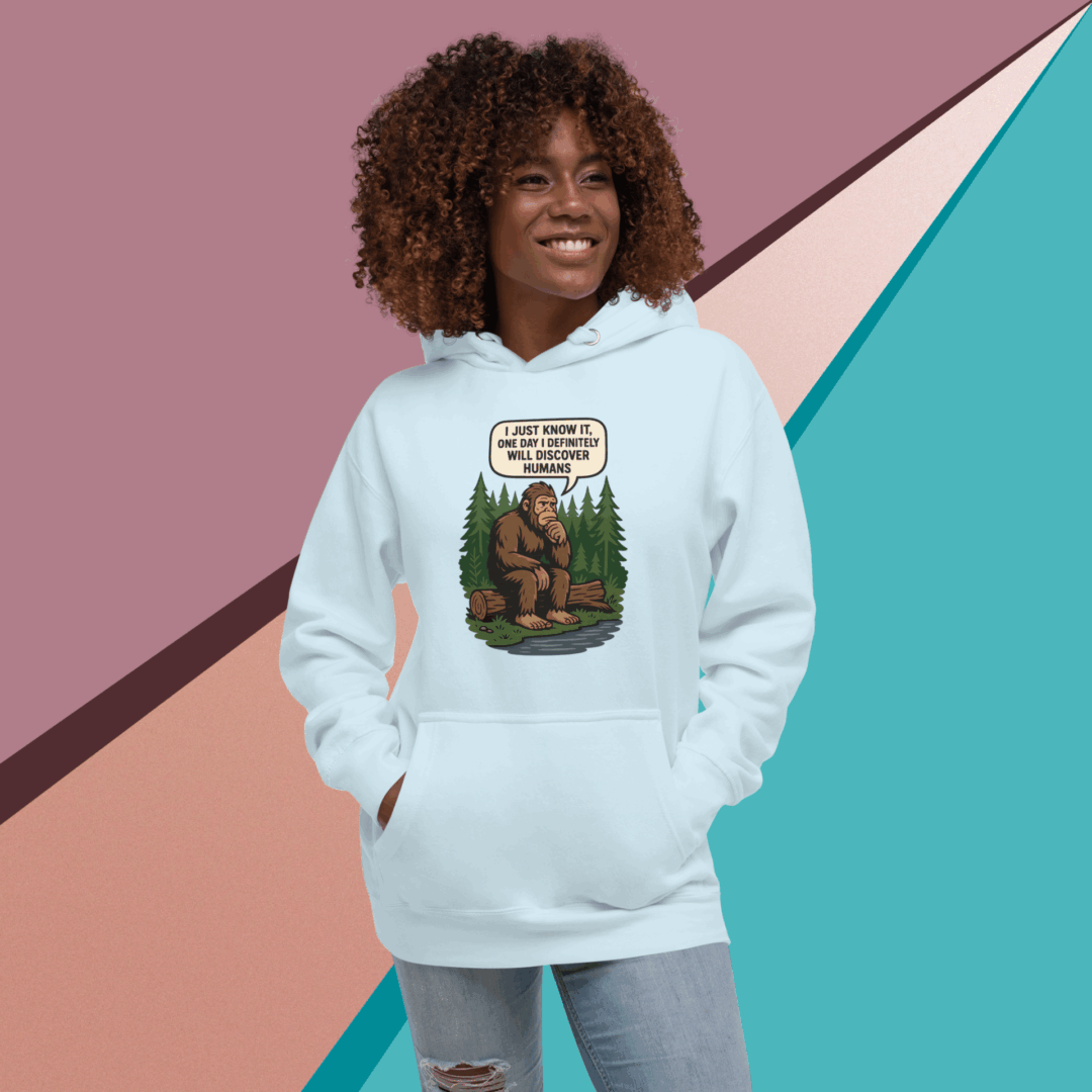 A smiling woman in a white hoodie with a graphic design stands against a colorful geometric background.