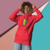 cotton-heritage-m2580-i-unisex-premium-pullover-hoodie-team-red-front-68e3254336d30 Smiling person wearing a red hoodie with a colorful graphic.