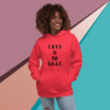 Person wearing a red hoodie with 'LOVE is the G.O.A.T.' text.