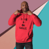 Man in red hoodie with 'LOVE is the G.O.A.T.' text.
