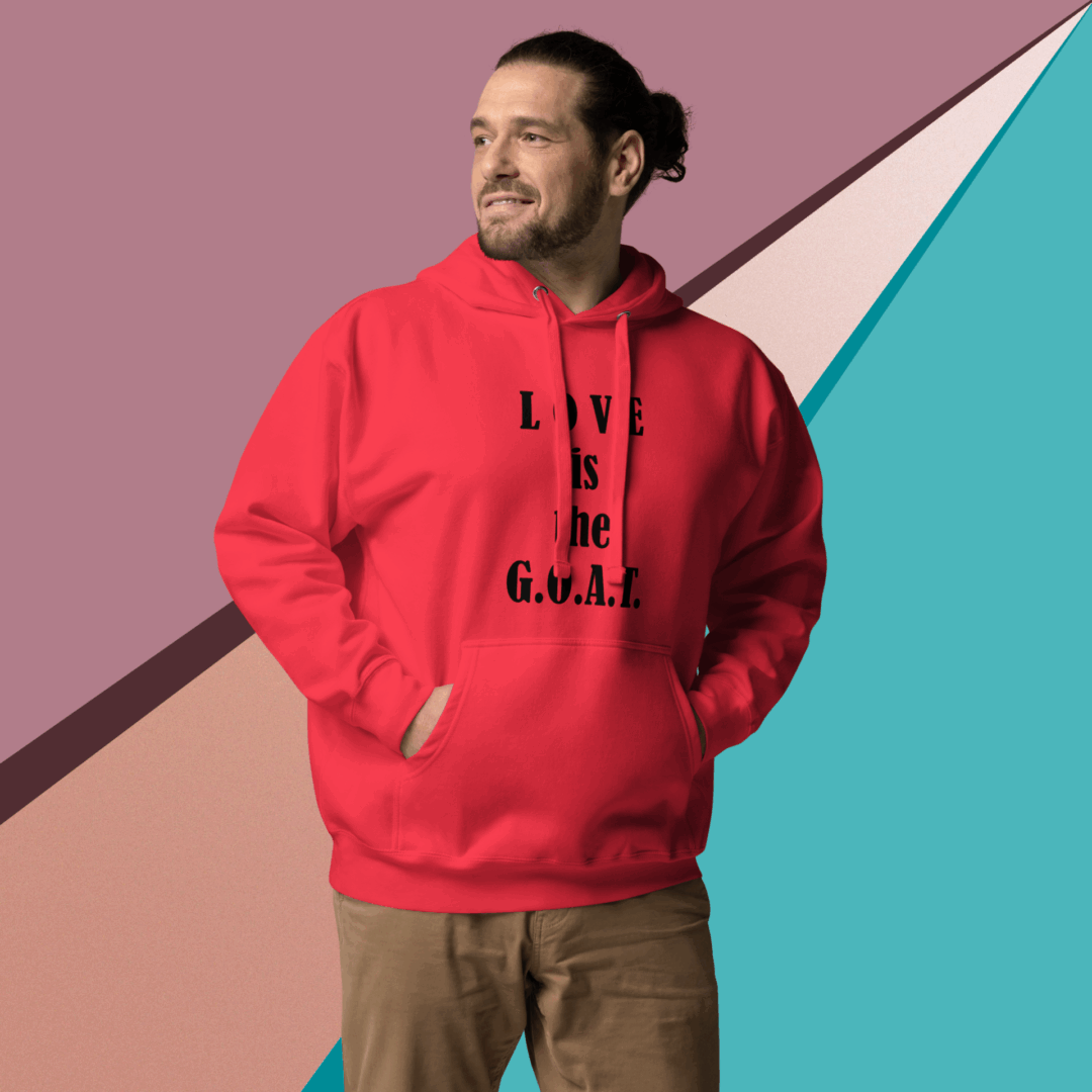 Man in red hoodie with text, standing against colorful geometric background.