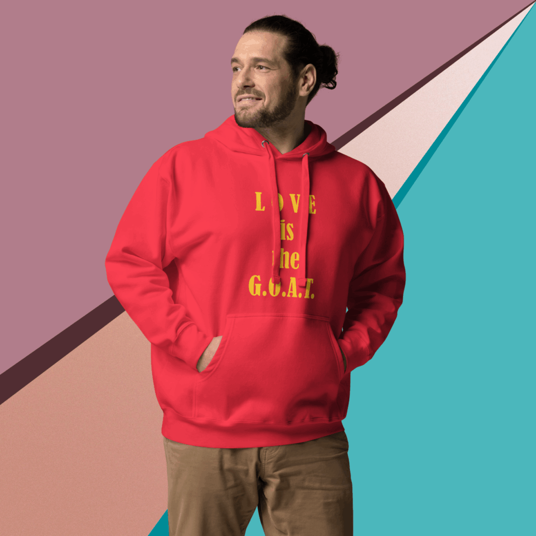 Man in a red hoodie standing against a colorful geometric background.