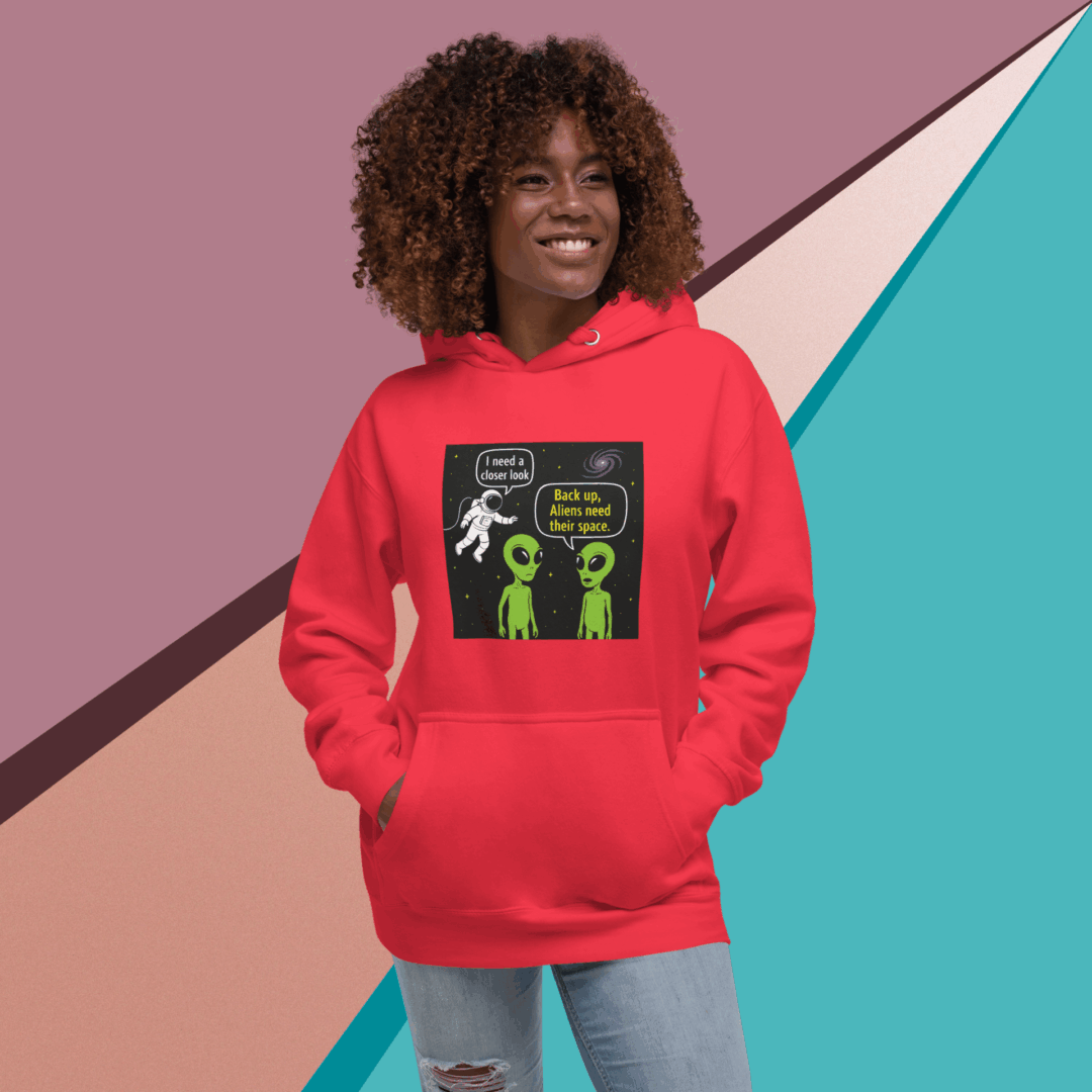 A smiling woman in a red hoodie stands against a colorful geometric background.