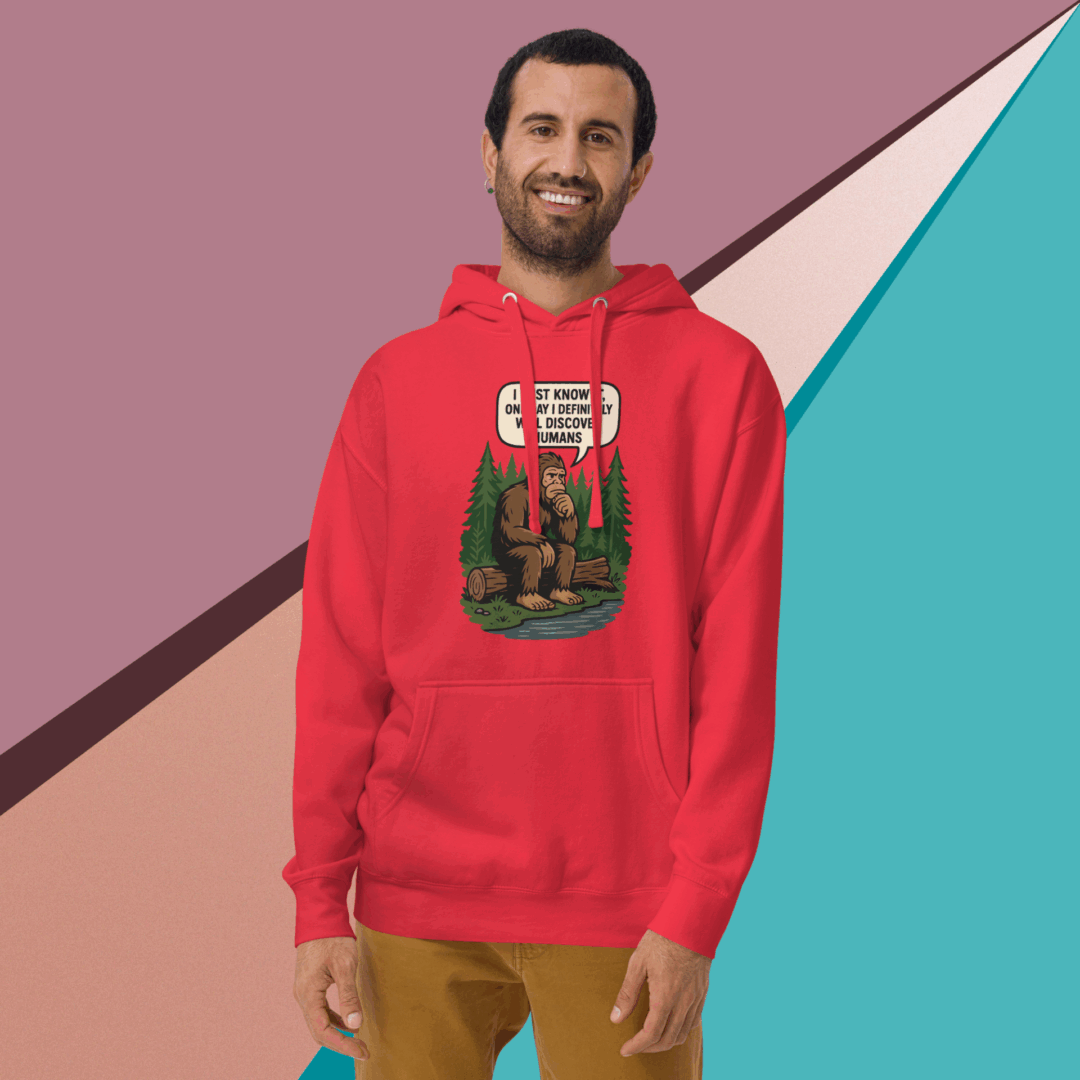 Smiling man wearing a red hoodie with a graphic design.