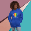 Smiling woman wearing a colorful rainbow-themed blue hoodie.