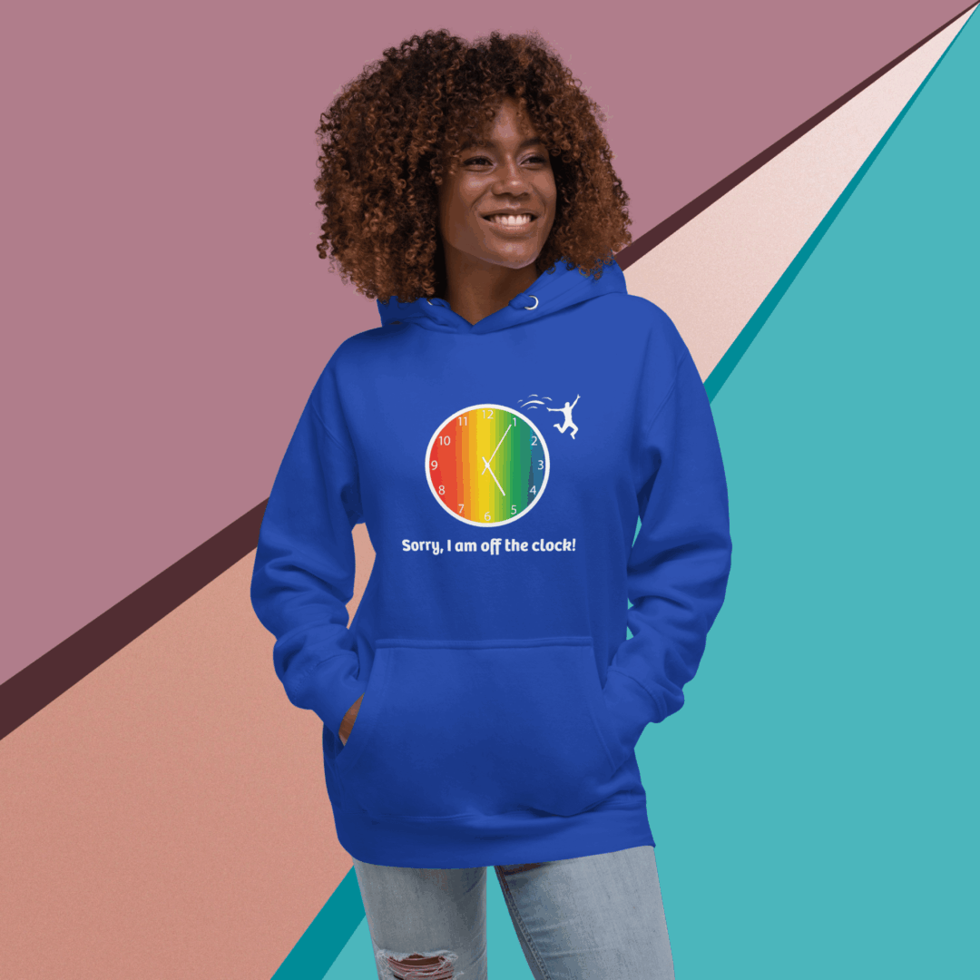 Smiling woman wearing a colorful rainbow-themed blue hoodie.