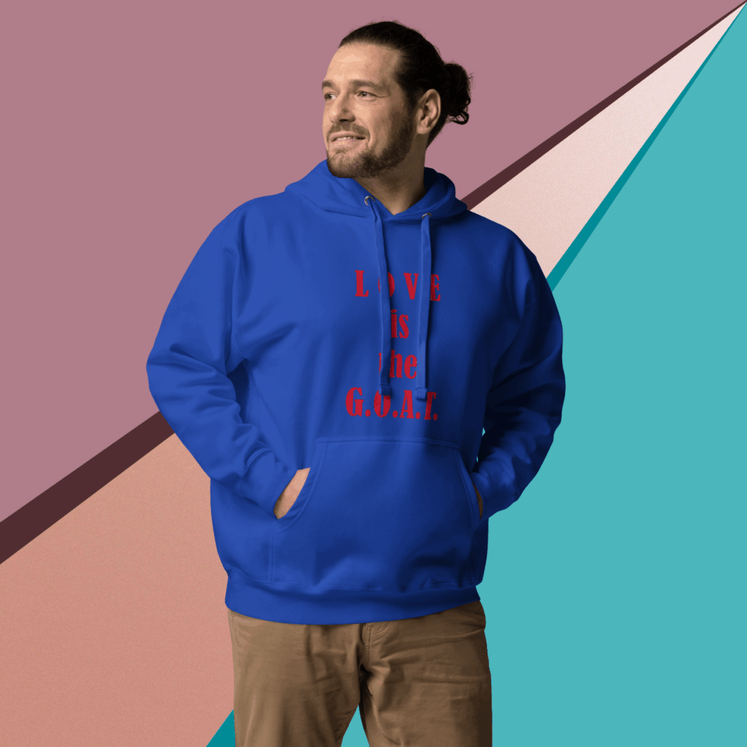 Man in blue hoodie with red text posing against a colorful geometric background.