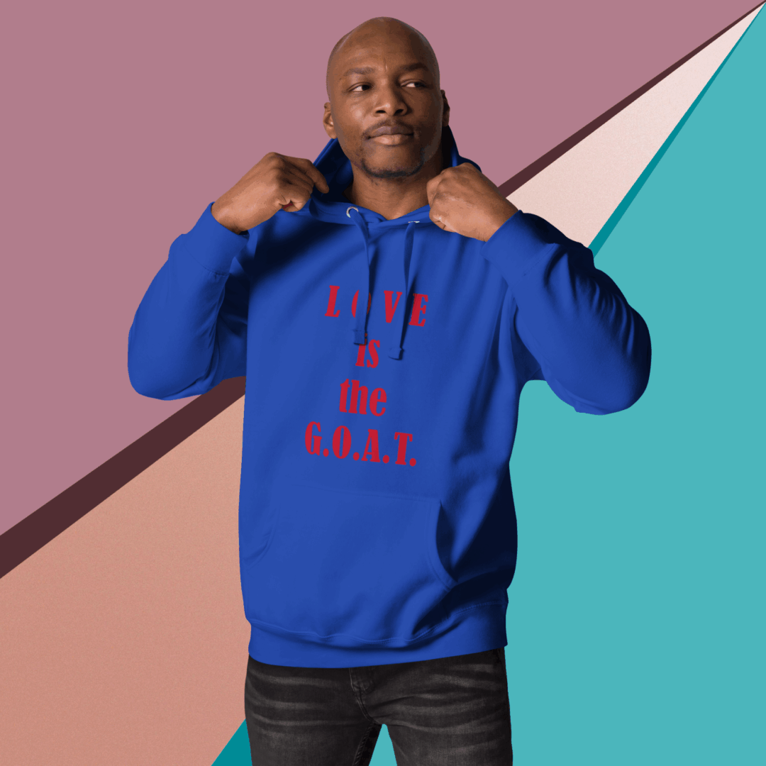 Man in blue hoodie pointing at text on it with colorful geometric background.